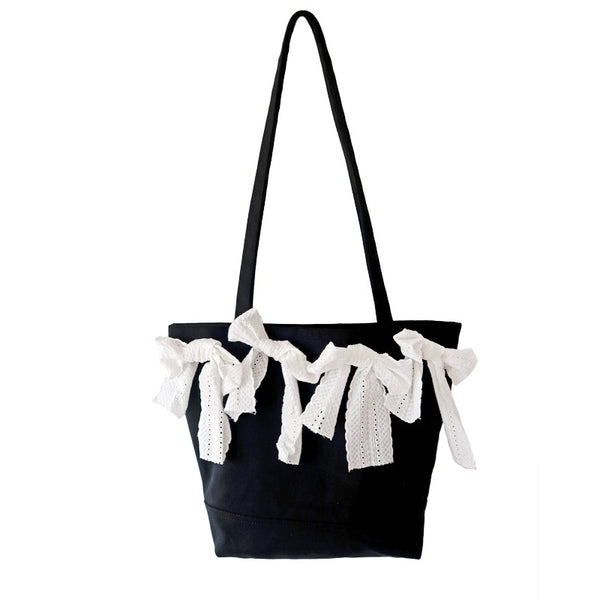 Canvas messenger bag with a trendy bow tie detail